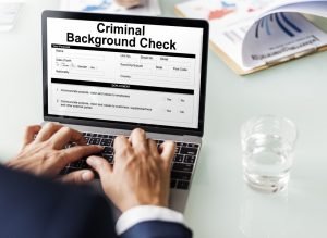 Man checking the criminal background check of the new hire Man checking the criminal background check of the new hire