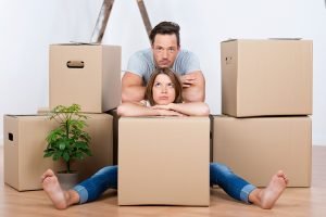 Couple Sitting Between Boxes