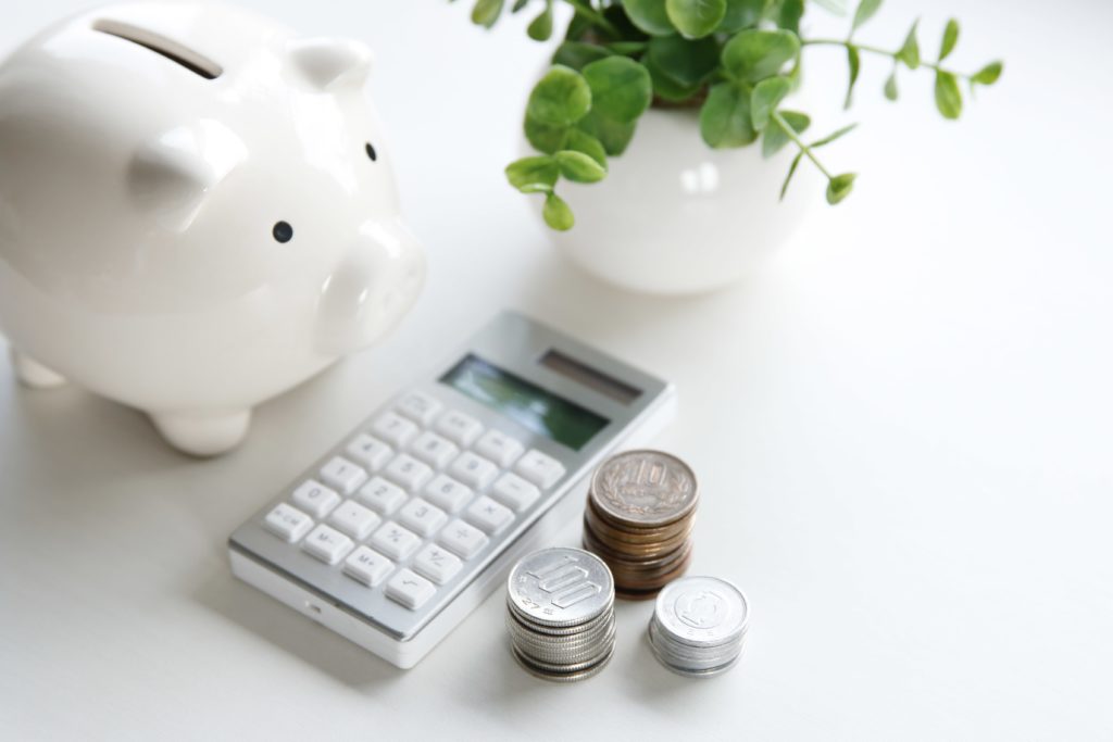 money, calculator, and a piggy bank